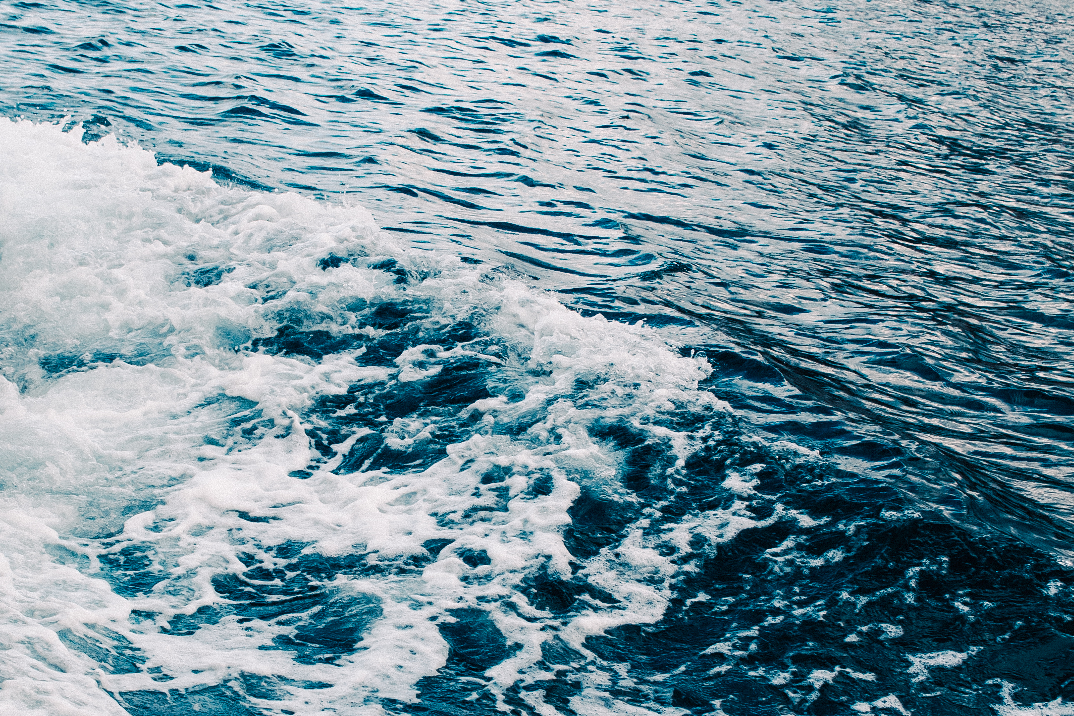 Boat wake on the deep blue water off the coast of Capri, Italy